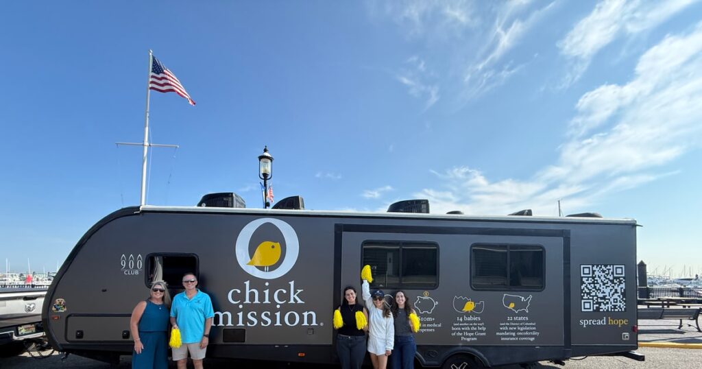 The Chick Mission road trip camper at the Atlantic Highlands marina launch, with Adaptive IT and Chick Mission supporters.